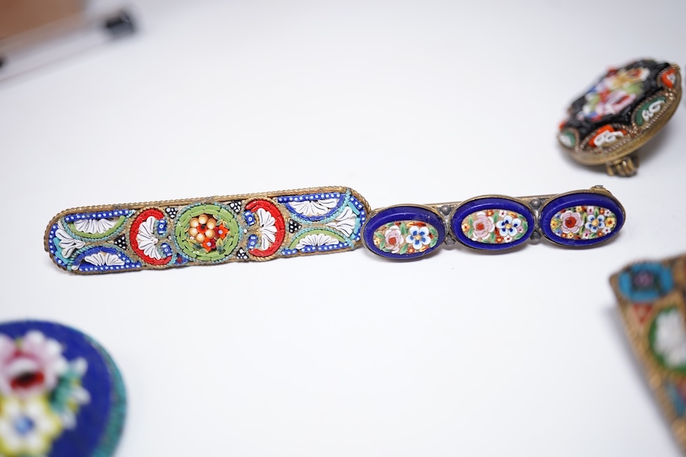 A collection of twenty-eight micro-mosaic brooches, including ten banjo and guitars shaped brooches, six similar large oval brooches, nine small brooches and three long brooches. (28) Condition - good
